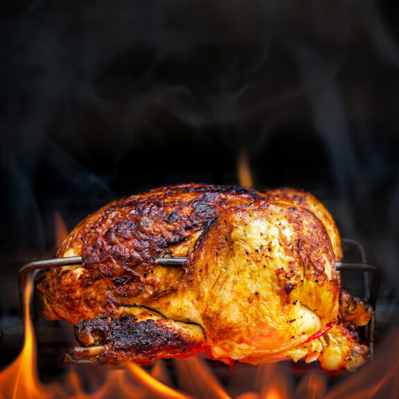 Rotisserie Chicken Cooking Over Open Flames